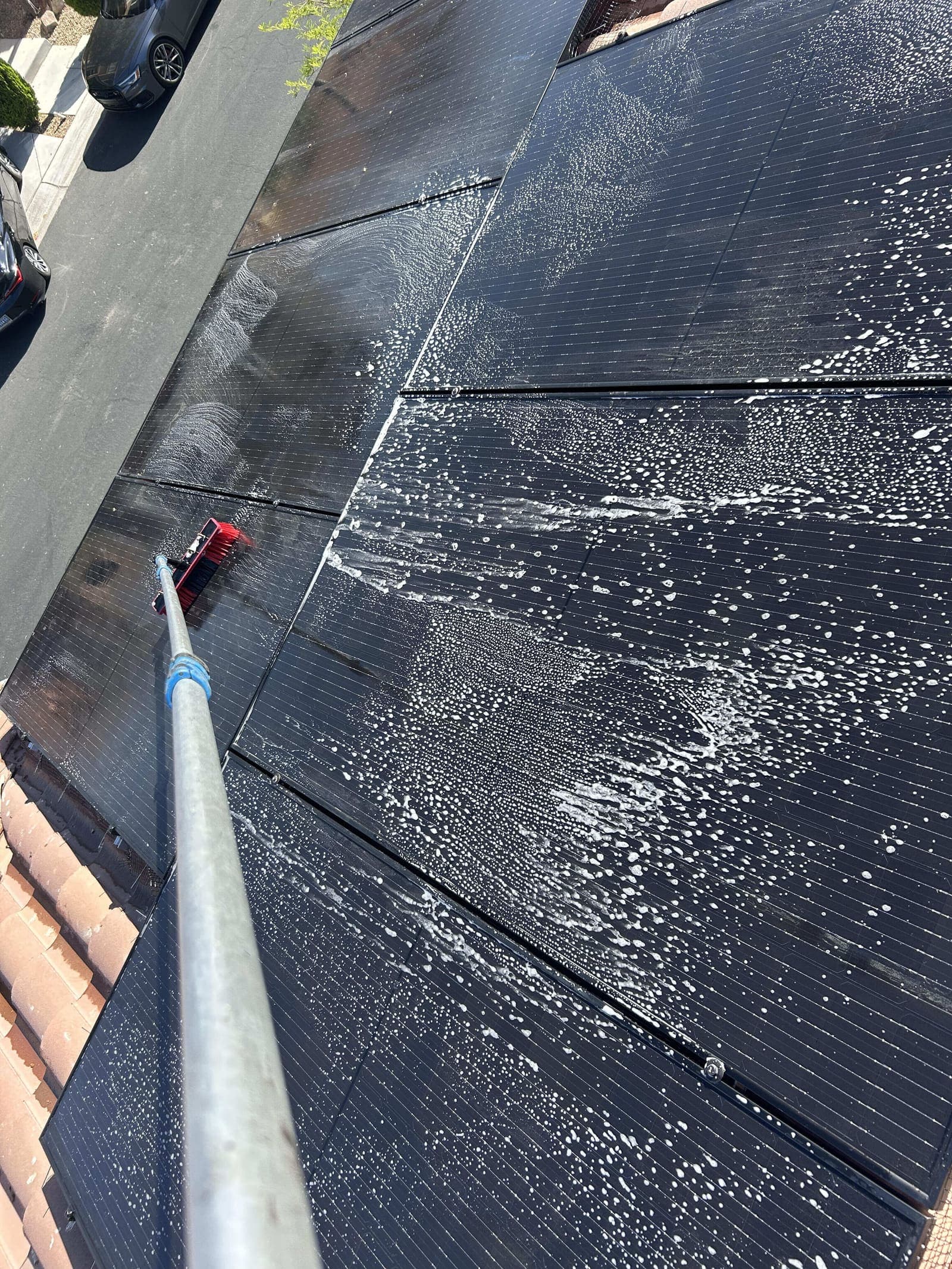 Solar panels being scrubbed with suds